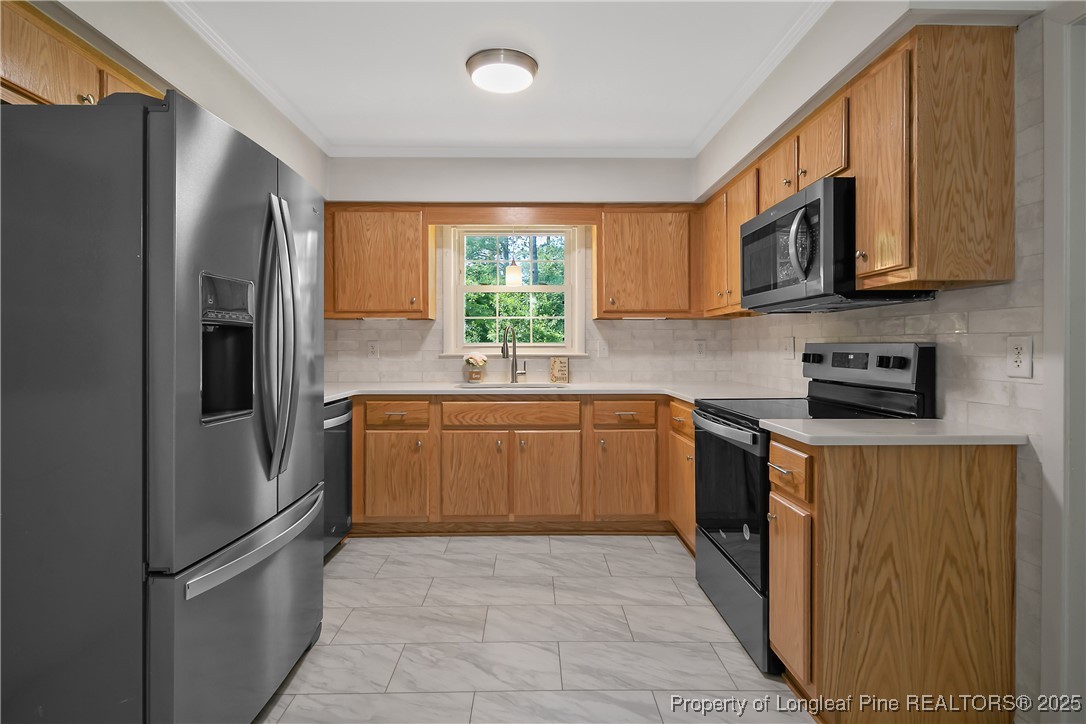7118 Fillyaw Road Fayetteville, NC 28303 - Photo 17 of 45 a kitchen with stainless steel appliances granite countertop a refrigerator stove top oven and sink