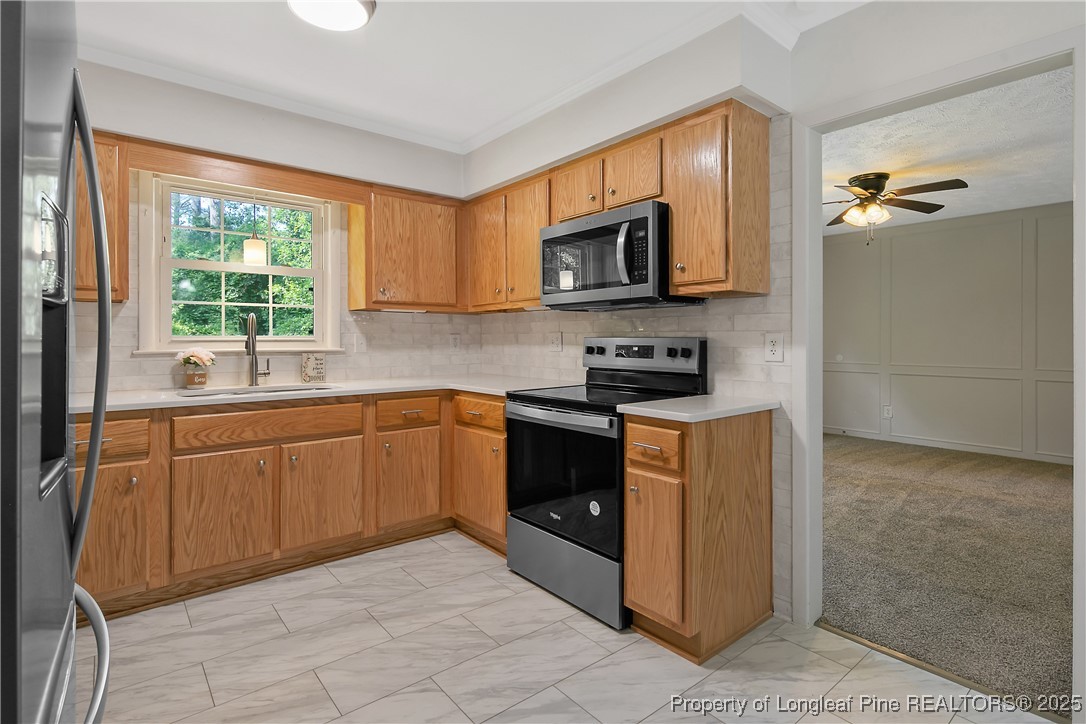 7118 Fillyaw Road Fayetteville, NC 28303 - Photo 18 of 45 a kitchen with stainless steel appliances granite countertop a refrigerator and a sink