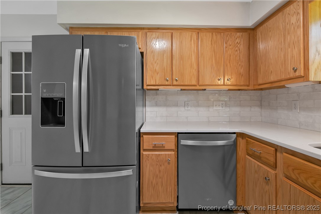 7118 Fillyaw Road Fayetteville, NC 28303 - Photo 19 of 45 a kitchen with metallic refrigerator freezer and a dishwasher