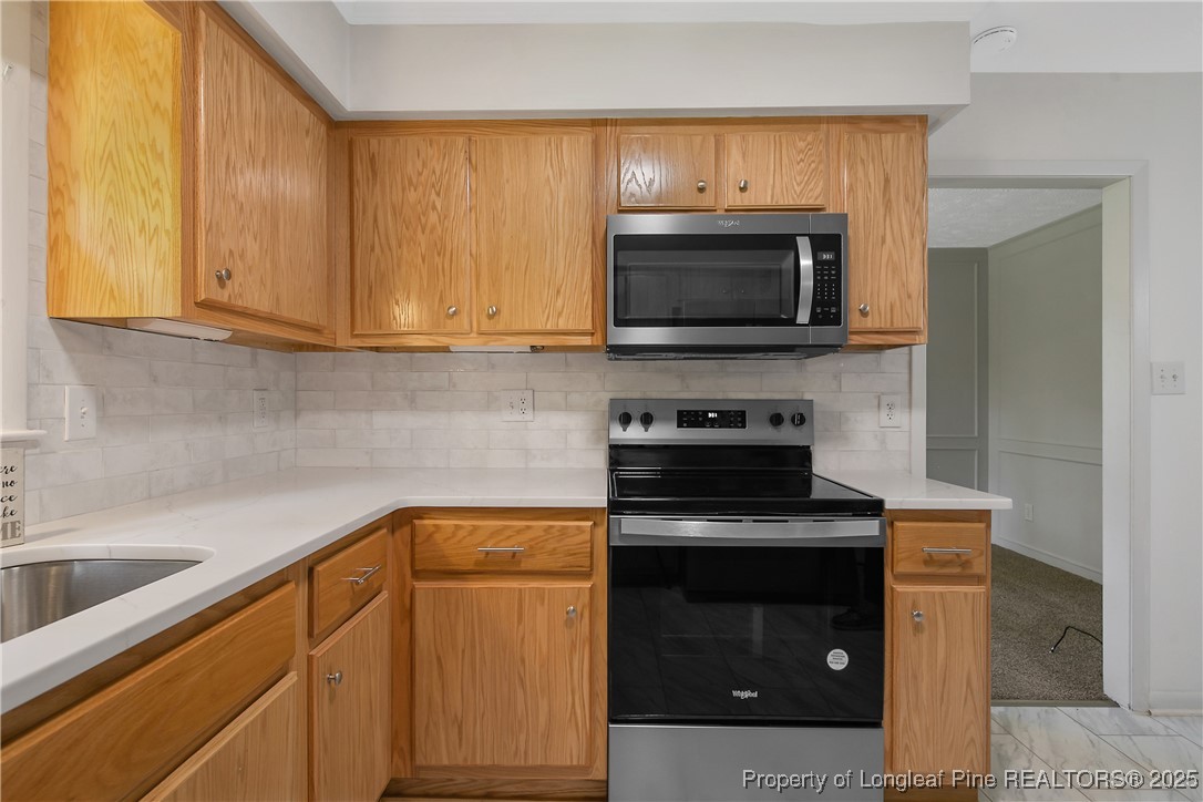 7118 Fillyaw Road Fayetteville, NC 28303 - Photo 20 of 45 a kitchen with a sink and a microwave
