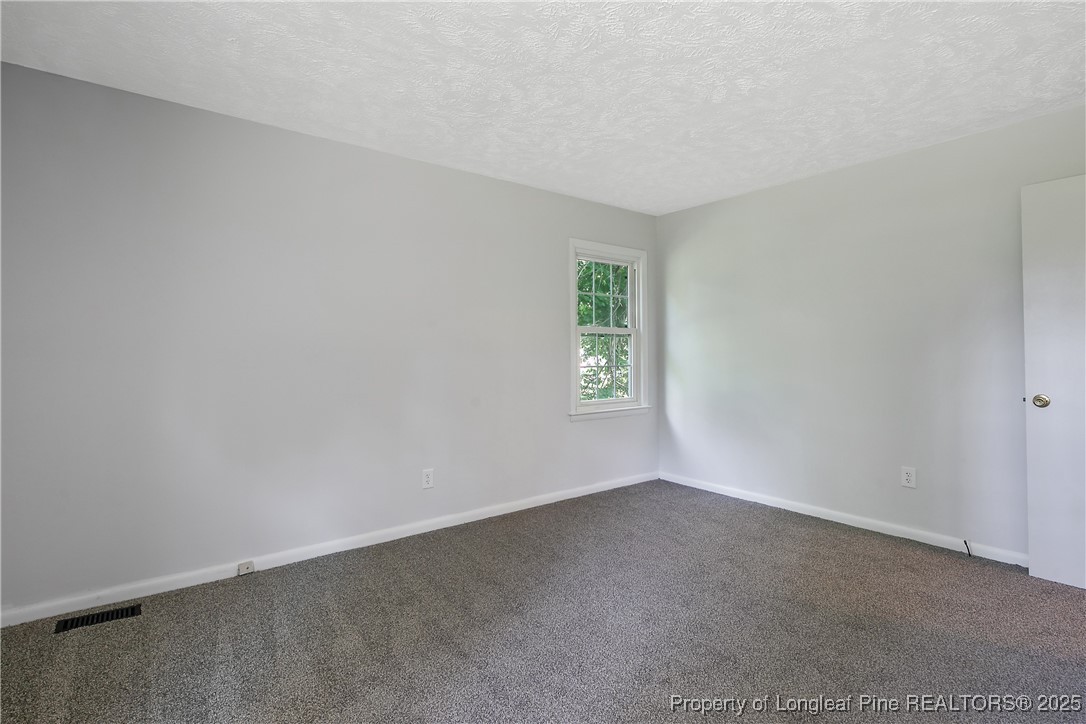 7118 Fillyaw Road Fayetteville, NC 28303 - Photo 23 of 45 an empty room with windows