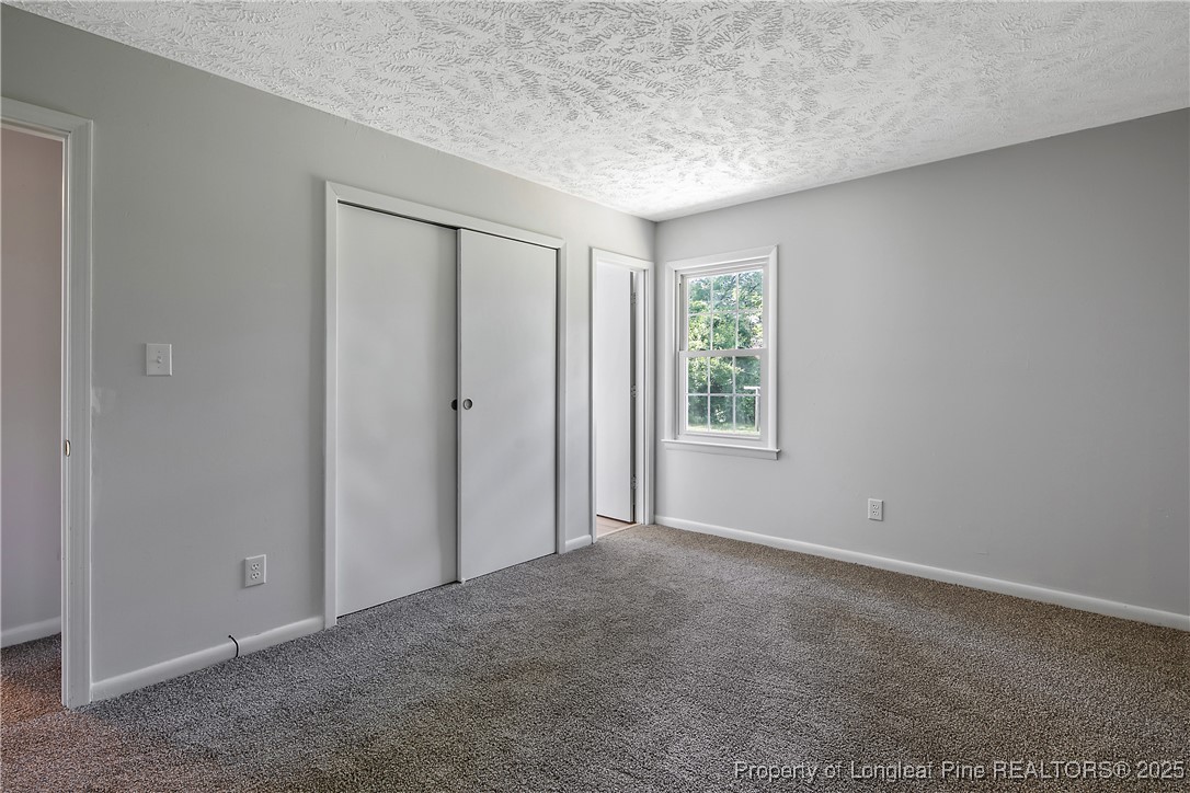 7118 Fillyaw Road Fayetteville, NC 28303 - Photo 25 of 45 an empty room with windows and closet