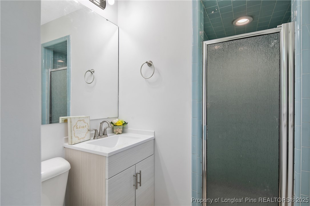 7118 Fillyaw Road Fayetteville, NC 28303 - Photo 27 of 45 a bathroom with a sink toilet and shower