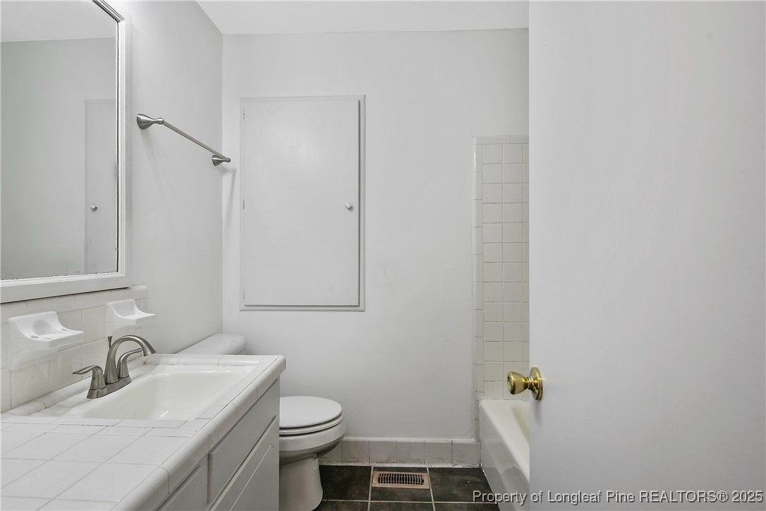 7118 Fillyaw Road Fayetteville, NC 28303 - Photo 32 of 45 a bathroom with a sink toilet and shower