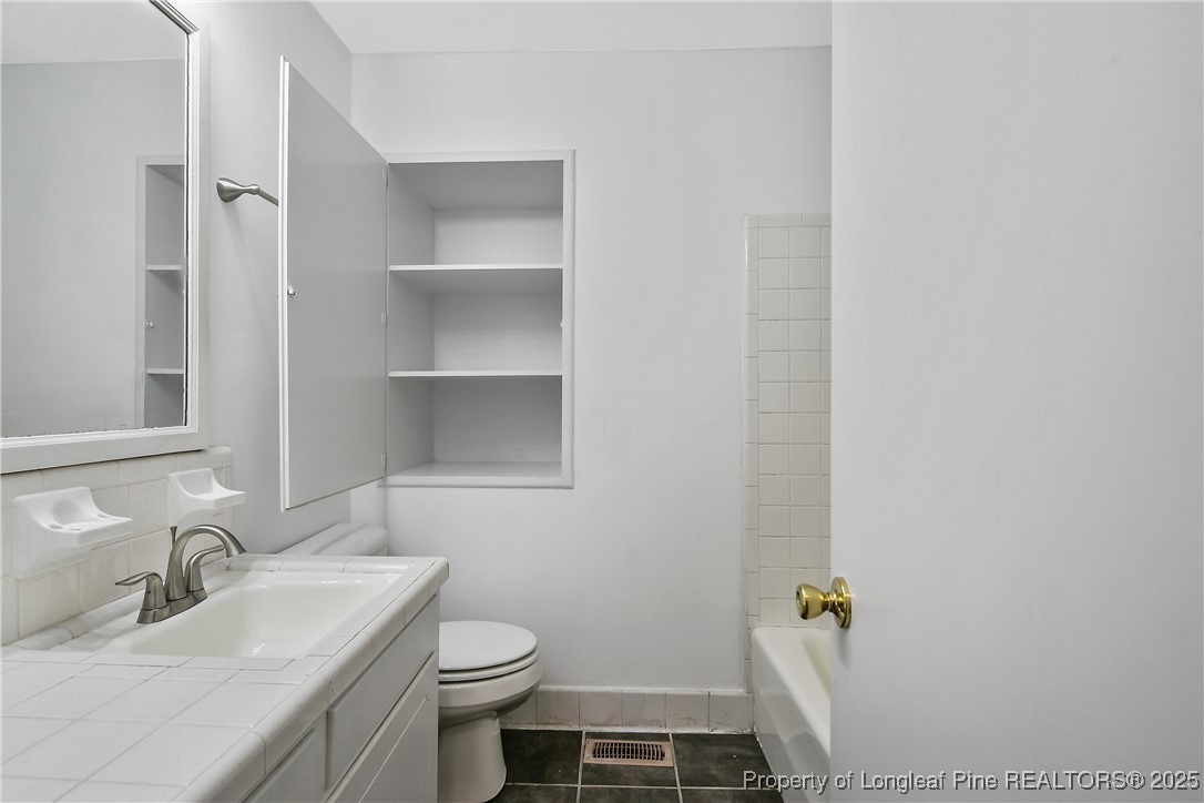 7118 Fillyaw Road Fayetteville, NC 28303 - Photo 33 of 45 a bathroom with a sink toilet and vanity