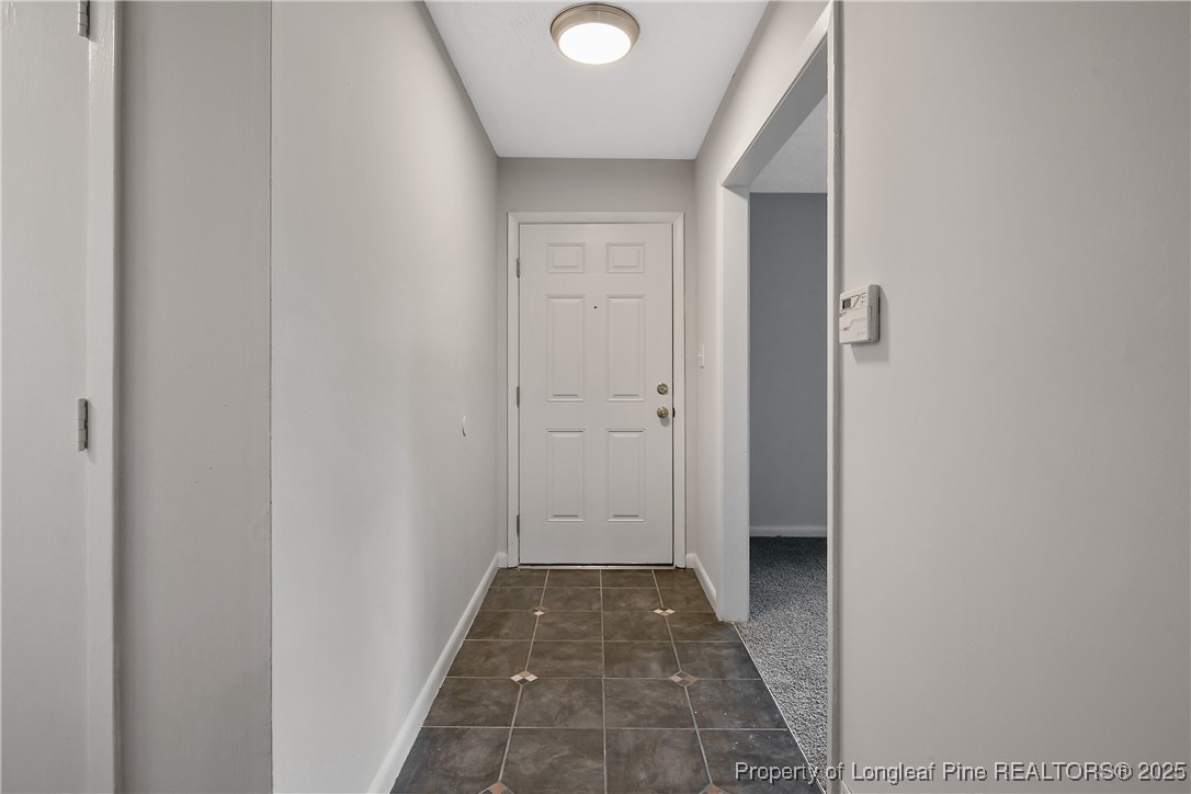 7118 Fillyaw Road Fayetteville, NC 28303 - Photo 6 of 45 a view of a hallway with wooden floor and a bathroom