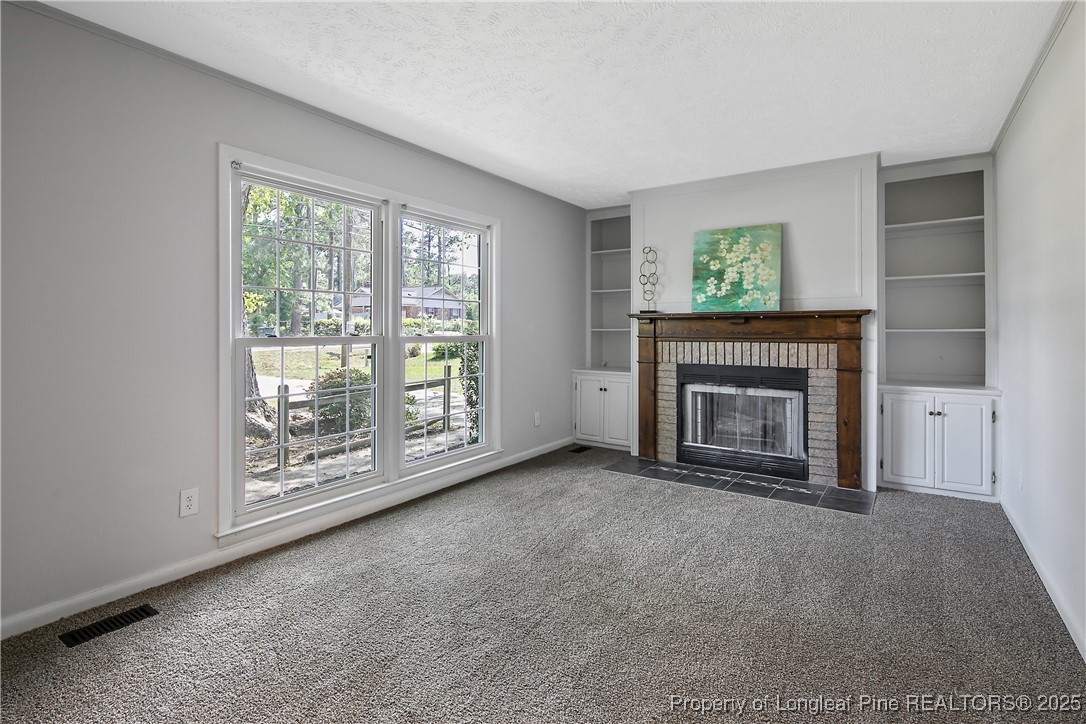 7118 Fillyaw Road Fayetteville, NC 28303 - Photo 7 of 45 a view of an empty room with a fireplace and a window