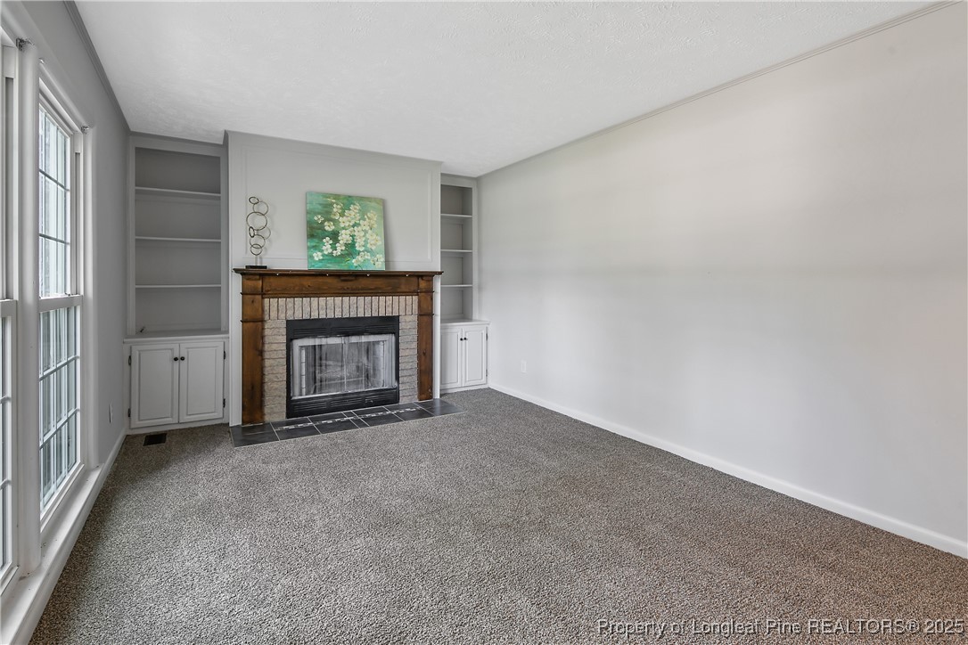 7118 Fillyaw Road Fayetteville, NC 28303 - Photo 9 of 45 a view of an empty room with a window and fireplace