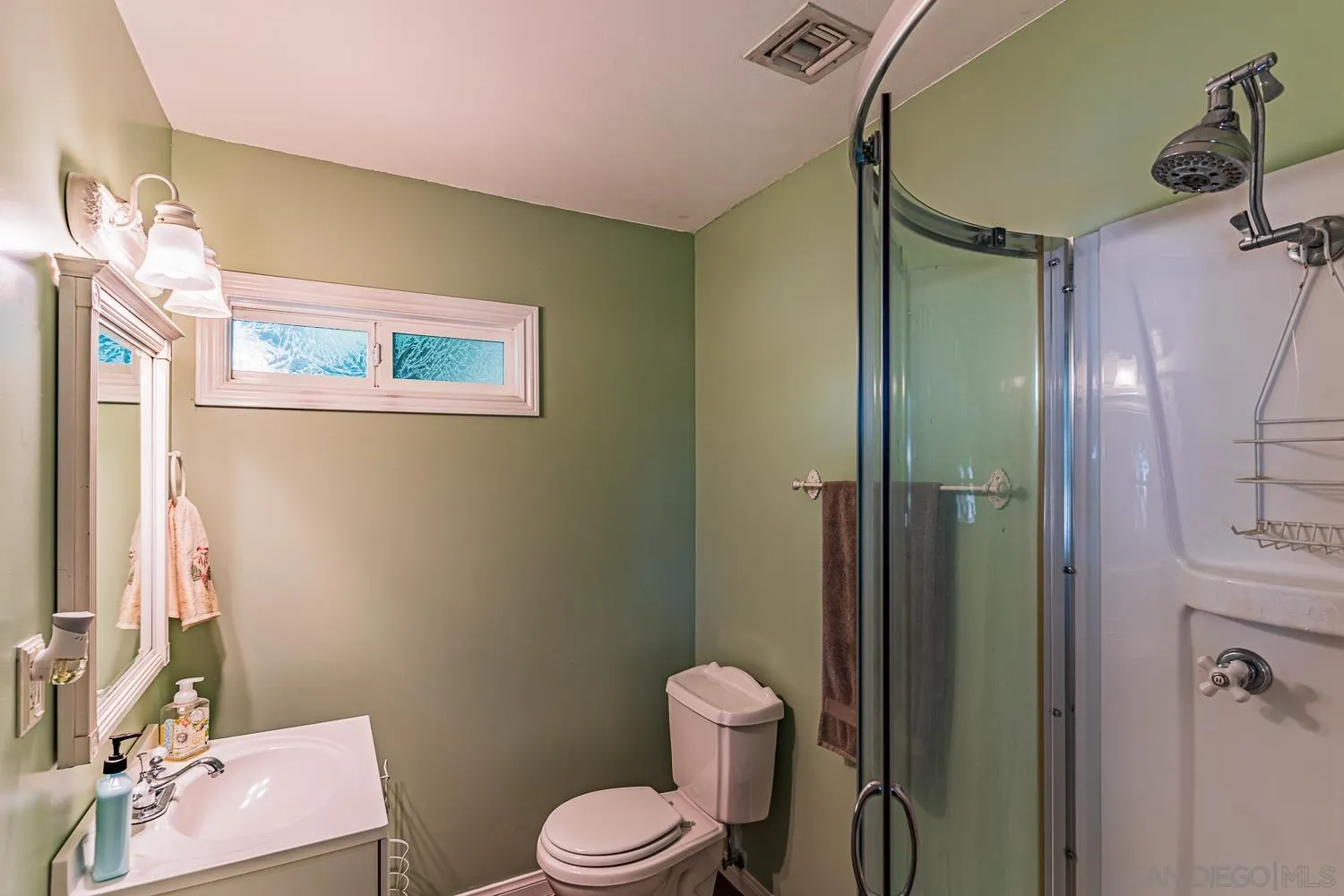 9213 Dalehurst Road Santee, CA 92071 - Photo 11 of 31 a bathroom with a toilet sink vanity and shower