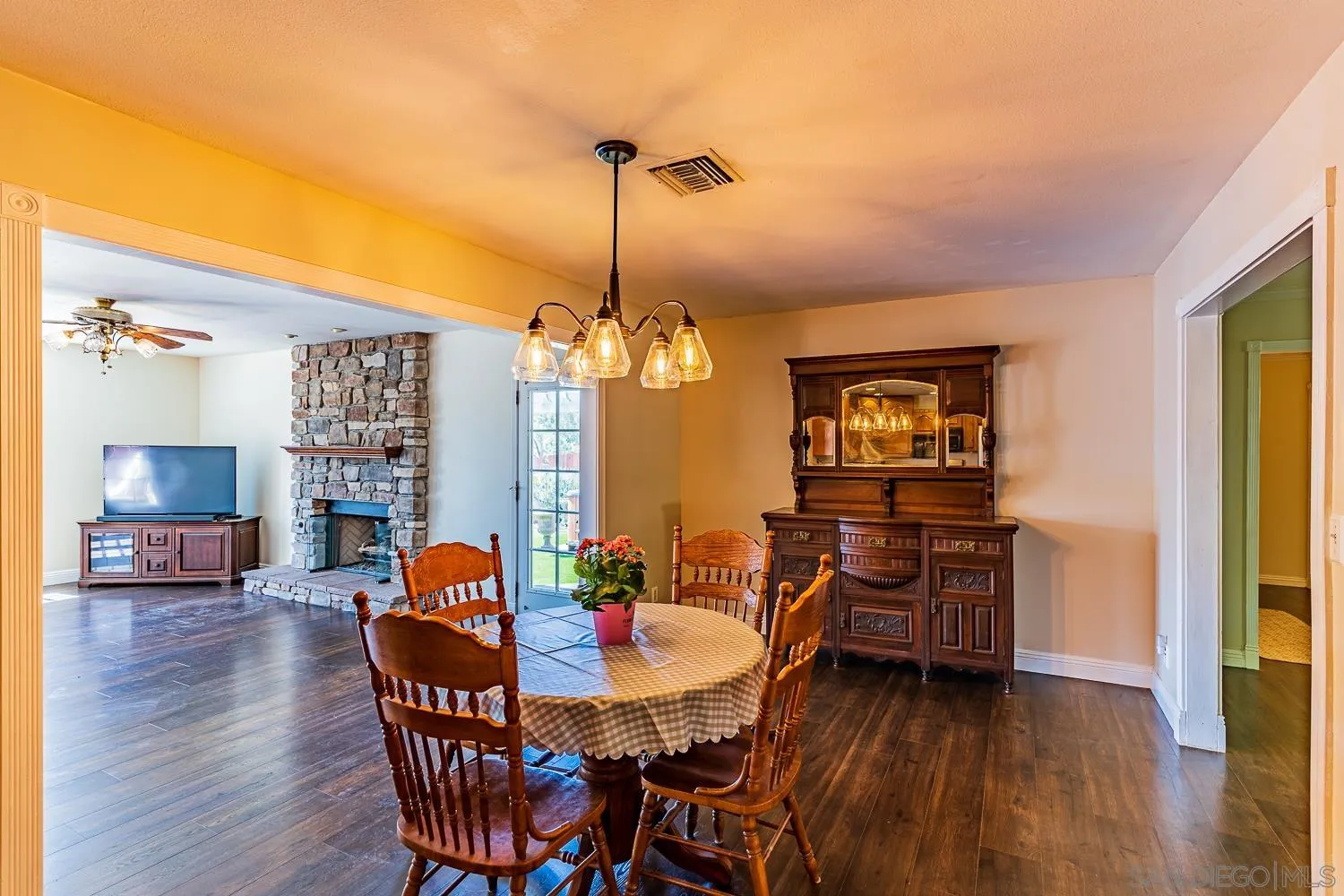 9213 Dalehurst Road Santee, CA 92071 - Photo 7 of 31 a view of a dining room with furniture wooden floor and a chandelier