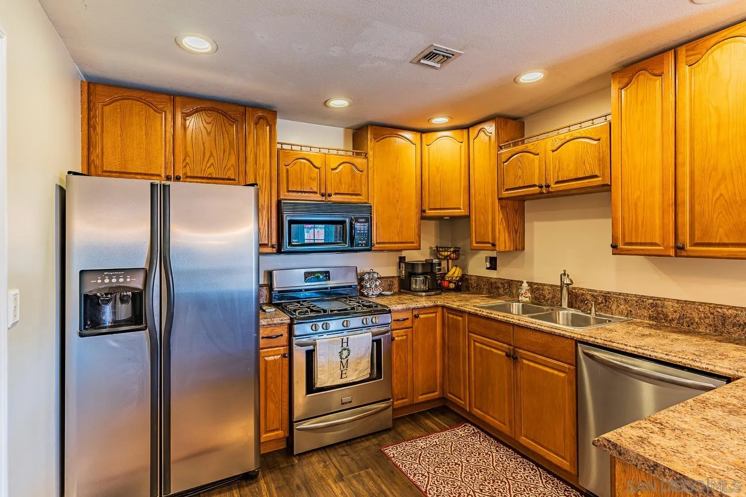9213 Dalehurst Road Santee, CA 92071 - Photo 8 of 31 a kitchen with stainless steel appliances granite countertop a stove a refrigerator and a sink