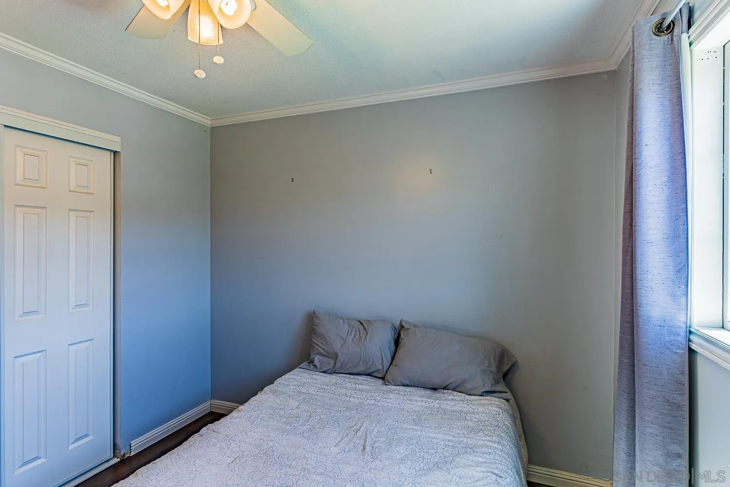 9213 Dalehurst Road Santee, CA 92071 - Photo 9 of 31 a bed room with a bed and a chandelier