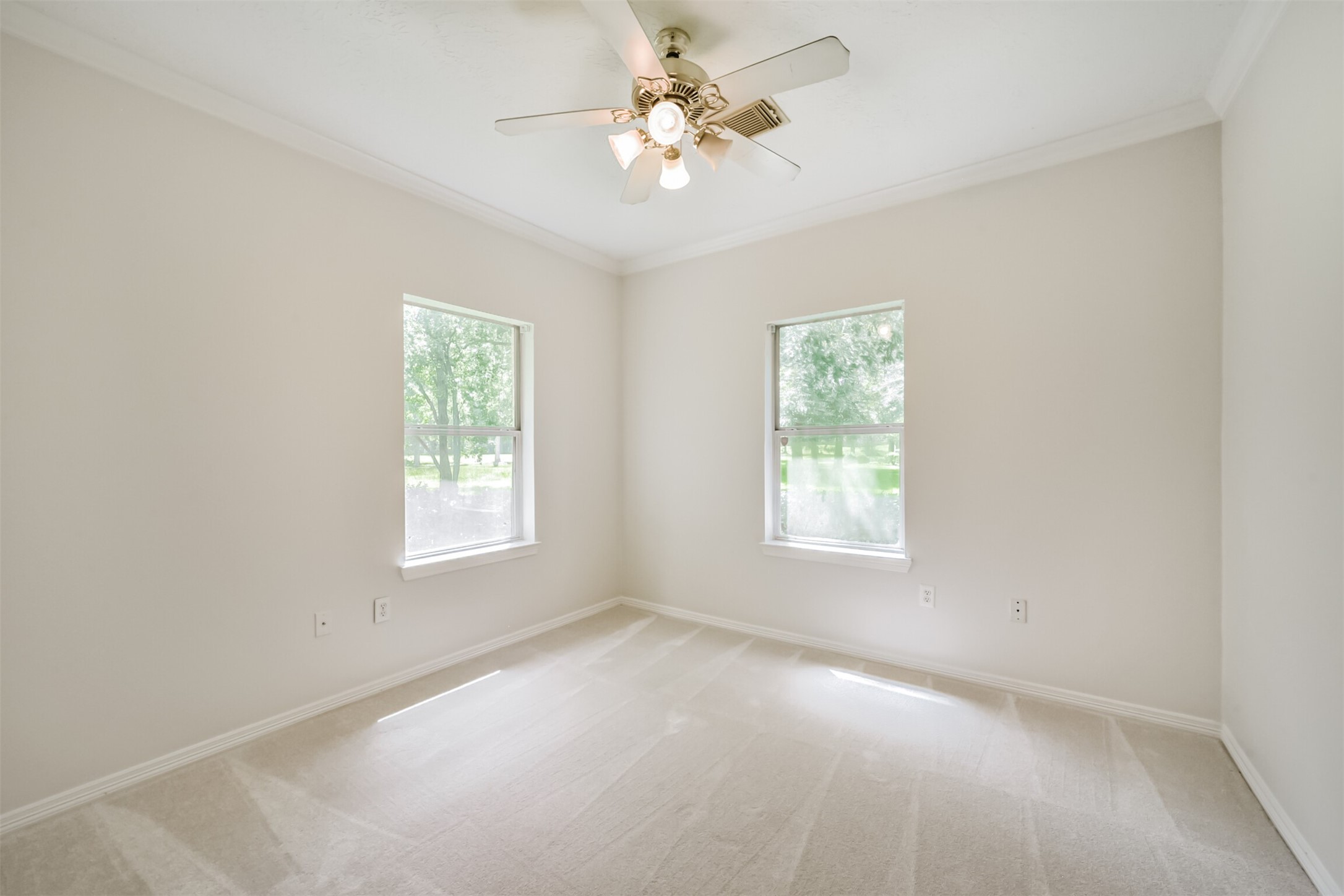 27322 Afton Way Huffman, TX 77336 - Photo 36 of 50 Secondary bedroom offers plush carpeting, crown molding, and peaceful natural light throughout.