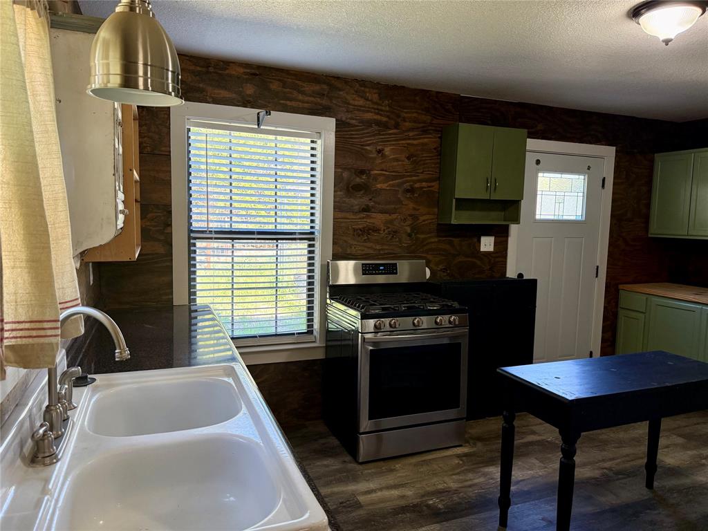 122 Tobacco Road Whitney, TX 76692 - Photo 12 of 35 a kitchen with a stove and a sink