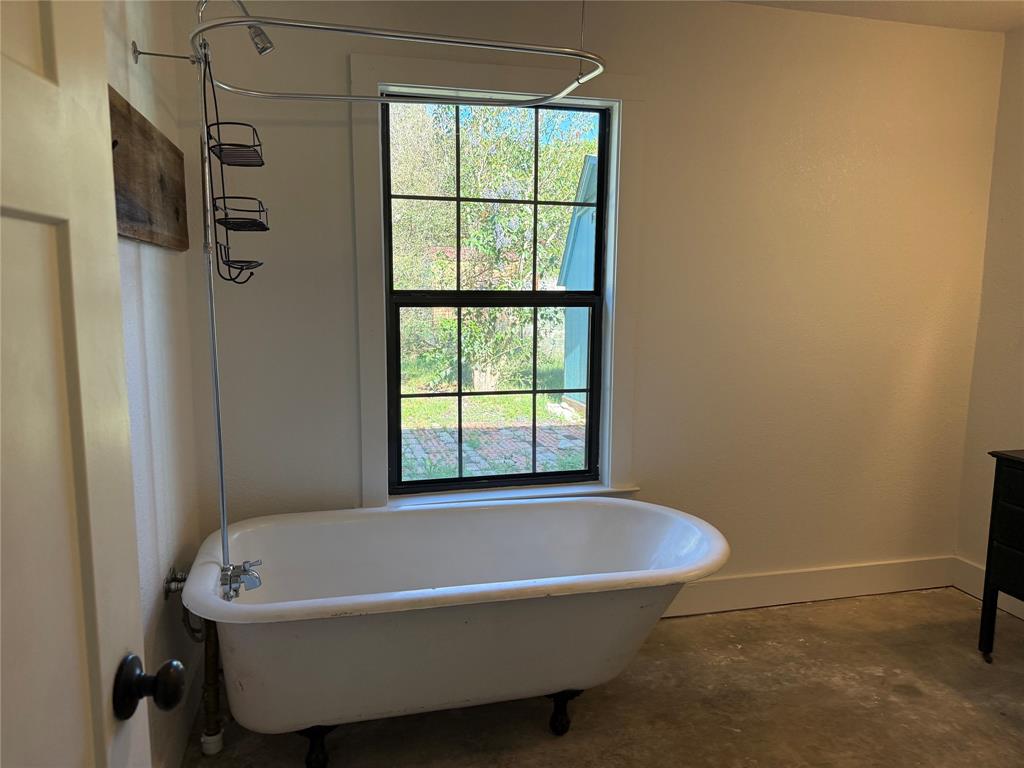 122 Tobacco Road Whitney, TX 76692 - Photo 17 of 35 a bathroom with a tub and a shower