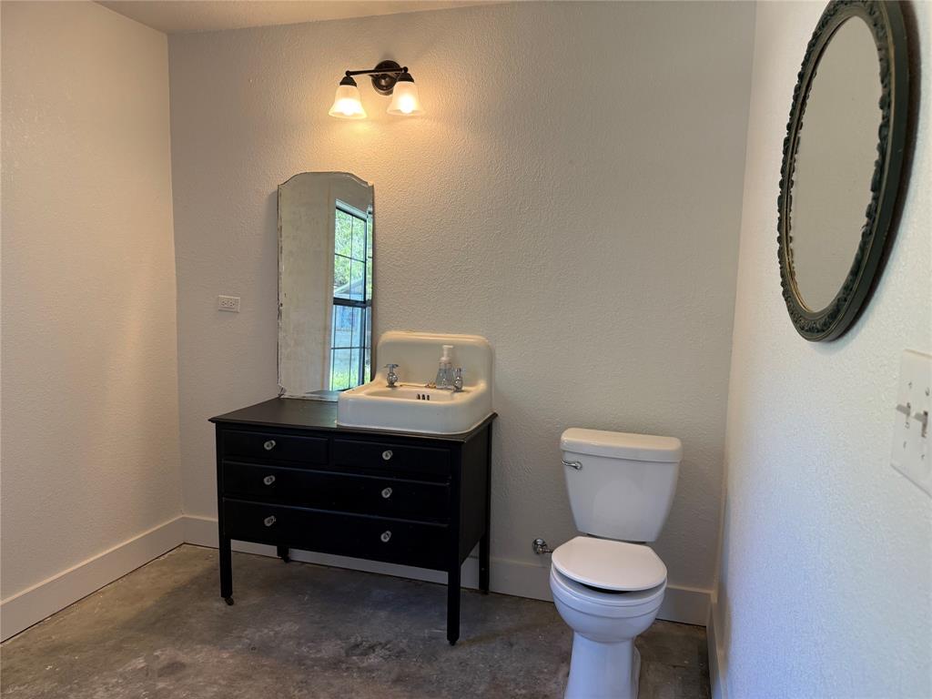 122 Tobacco Road Whitney, TX 76692 - Photo 18 of 35 a bathroom with a toilet sink and mirror