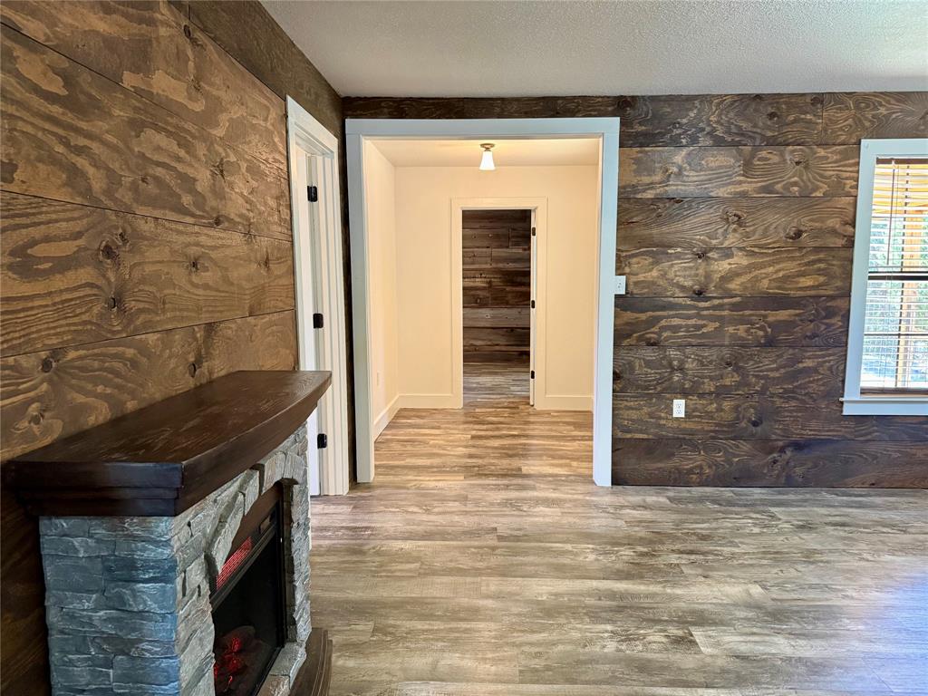 122 Tobacco Road Whitney, TX 76692 - Photo 22 of 35 a view of a hallway with wooden floor and staircase
