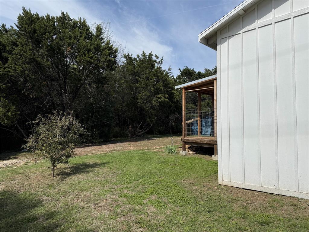 122 Tobacco Road Whitney, TX 76692 - Photo 24 of 35 a view of an house with backyard space and garden