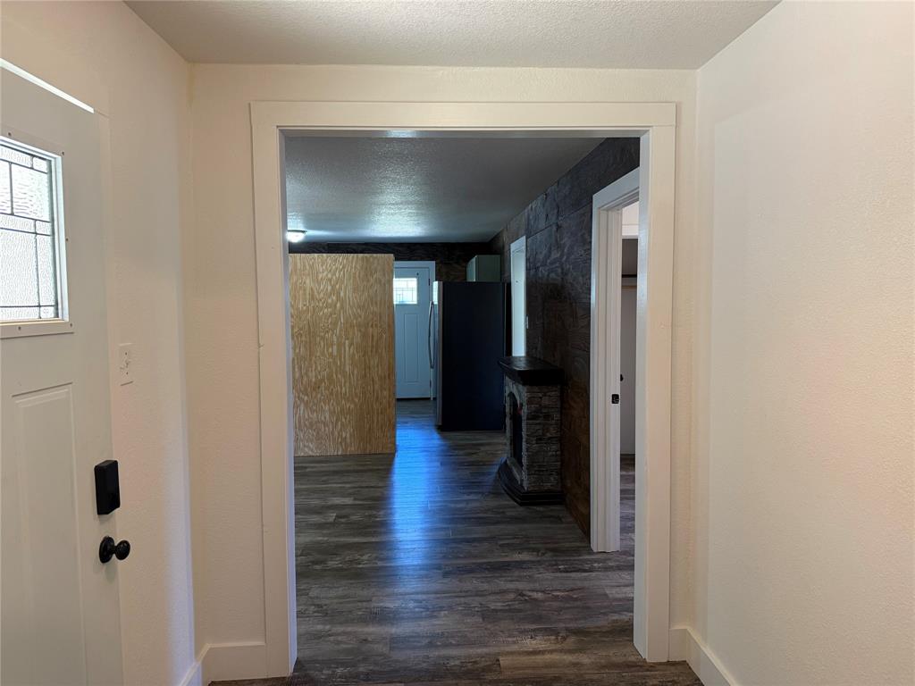 122 Tobacco Road Whitney, TX 76692 - Photo 9 of 35 a view of hallway with stairs and wooden floor