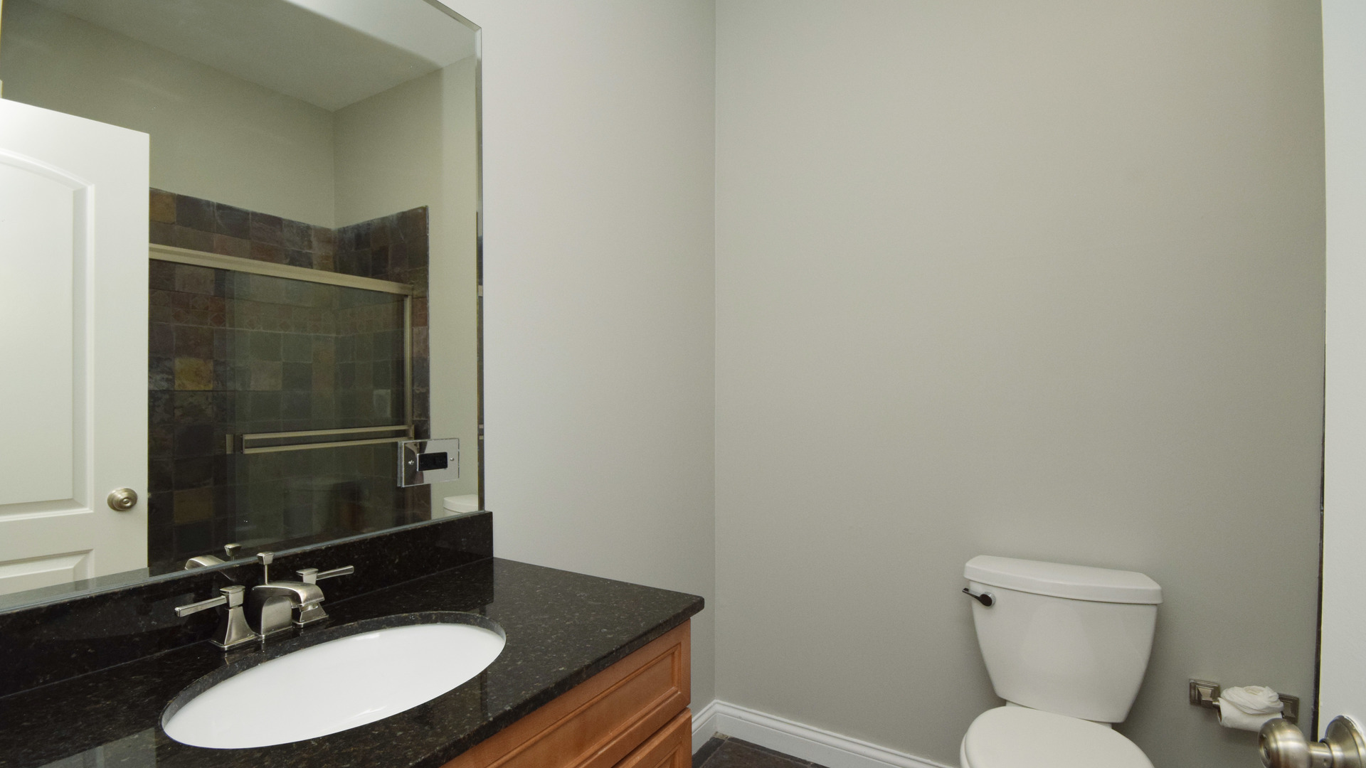 6065 North Ridge Avenue, Unit 2 Chicago, IL 60660 - Photo 12 of 17 a bathroom with a granite countertop sink toilet and a mirror
