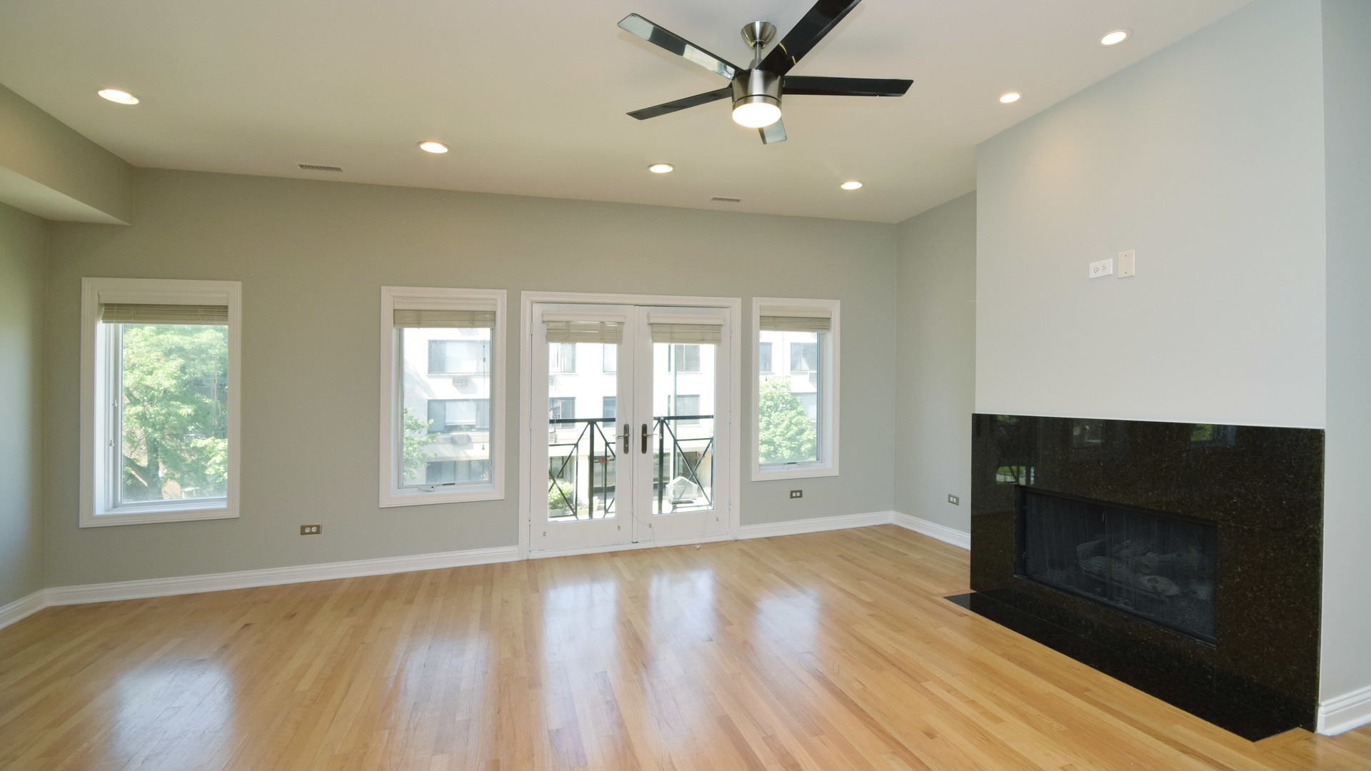 6065 North Ridge Avenue, Unit 2 Chicago, IL 60660 - Photo 2 of 17 a view of an empty room with a fireplace and a window