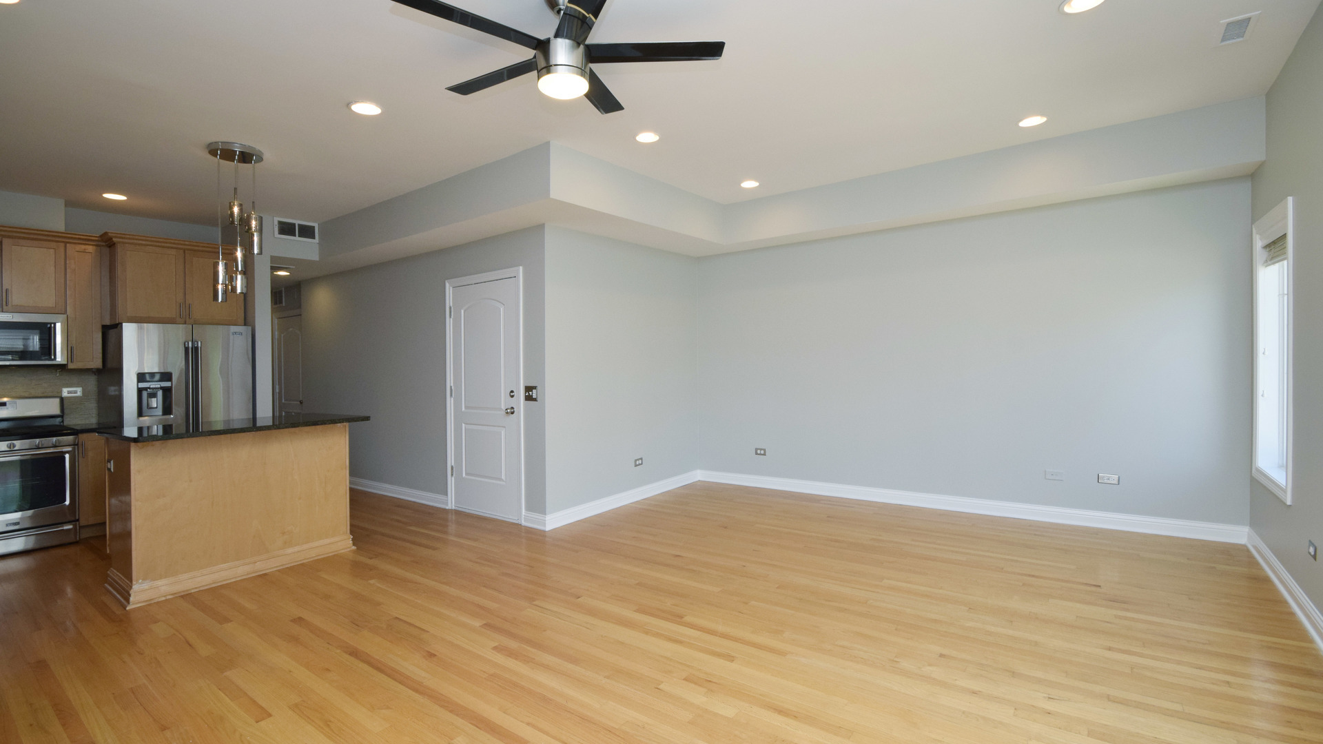 6065 North Ridge Avenue, Unit 2 Chicago, IL 60660 - Photo 5 of 17 wooden floor in an empty room with a window