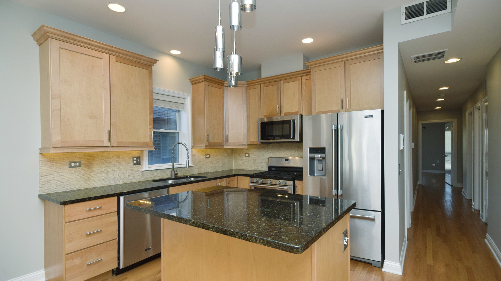 6065 North Ridge Avenue, Unit 2 Chicago, IL 60660 - Photo 6 of 17 a kitchen with stainless steel appliances granite countertop a sink a stove and a refrigerator