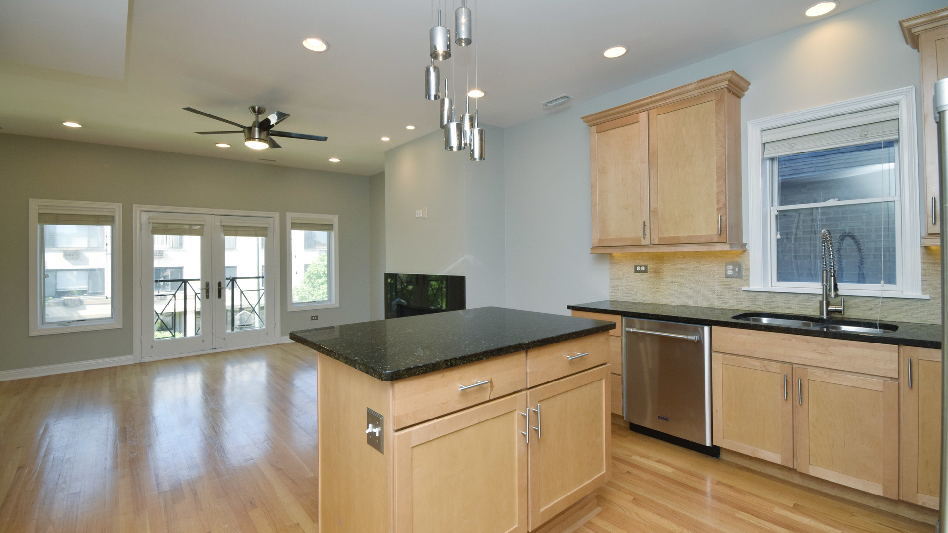 6065 North Ridge Avenue, Unit 2 Chicago, IL 60660 - Photo 7 of 17 a kitchen with stainless steel appliances granite countertop a sink a stove and a refrigerator