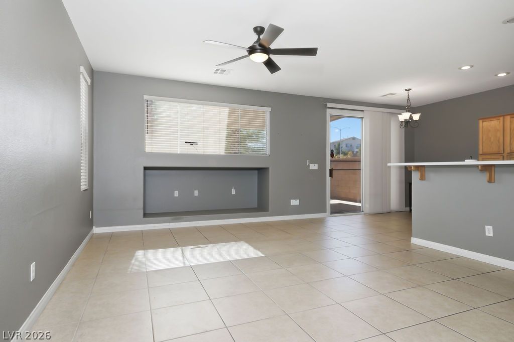 754 Solitude Point Avenue Henderson, NV 89012 - Photo 10 of 38 A spacious living area offers abundant natural light and an open-concept layout.