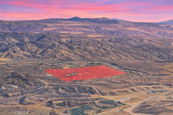 an aerial view of a house with a mountain