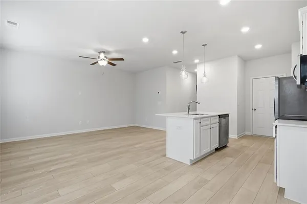 a view of kitchen with sink microwave and refrigerator