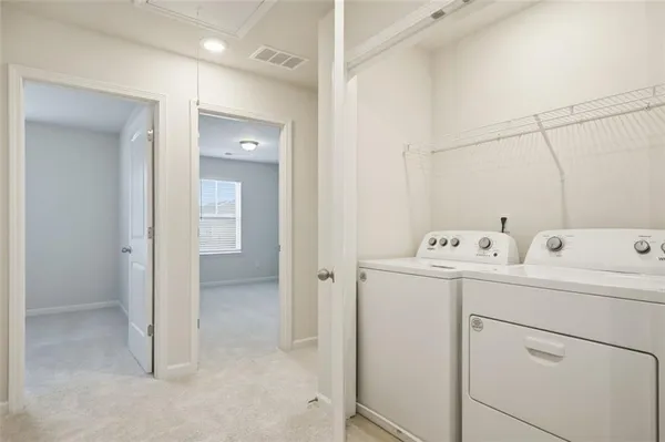 a view of a bathroom with sink mirror and window