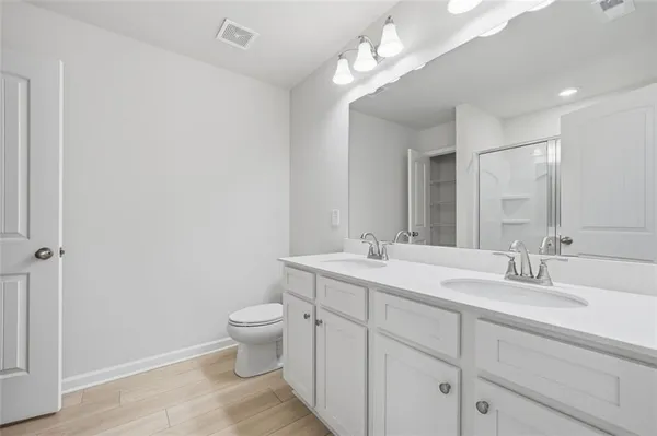 a bathroom with a shower and a glass door