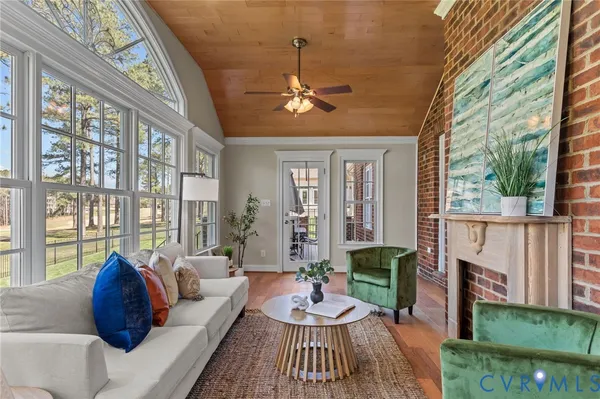 a kitchen with stainless steel appliances kitchen island granite countertop a dining table chairs and white cabinets