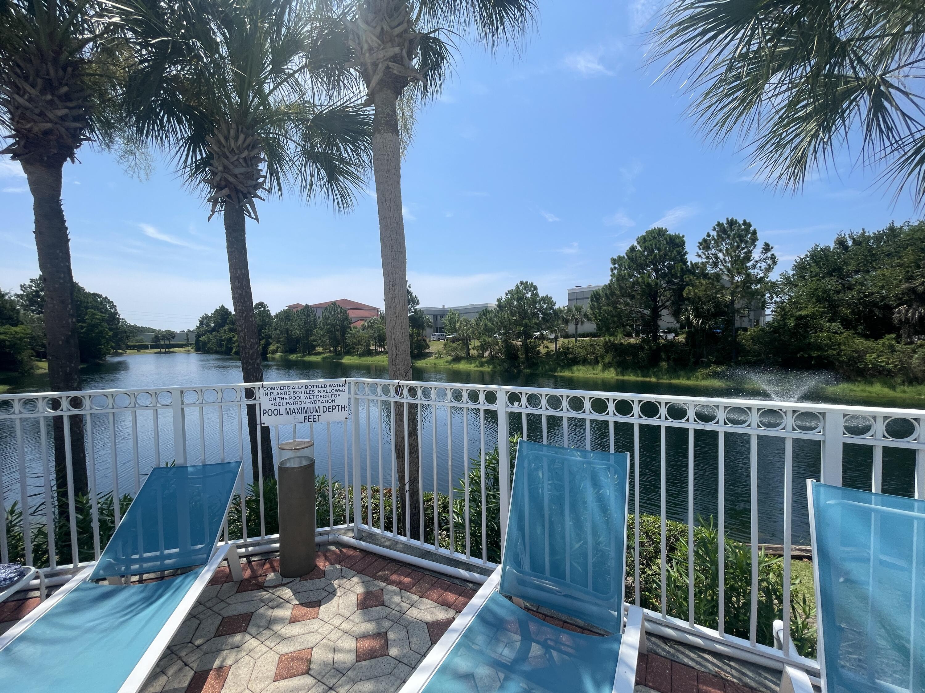 241 Inverrary Drive Destin, FL 32541 - Photo 1 of 24 a view of a wooden deck with a palm tree