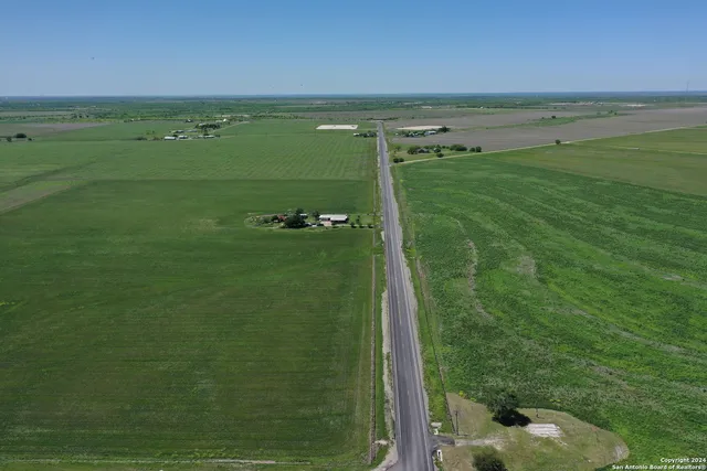 a view of a field with an ocean