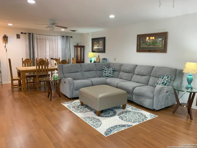 a living room with furniture and wooden floor