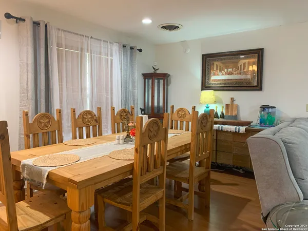 a view of a dining room with furniture and chandelier