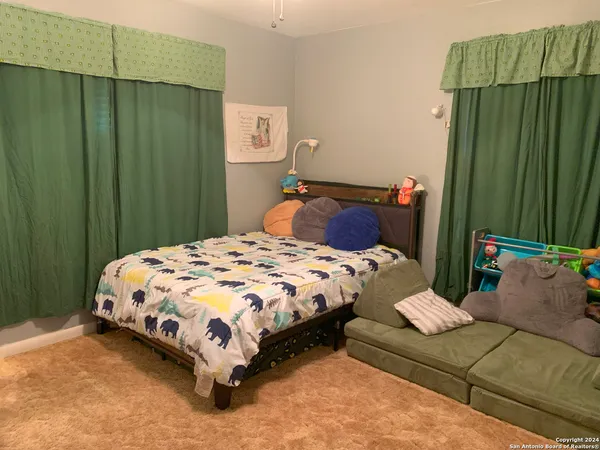 a bedroom with a bed and green walls