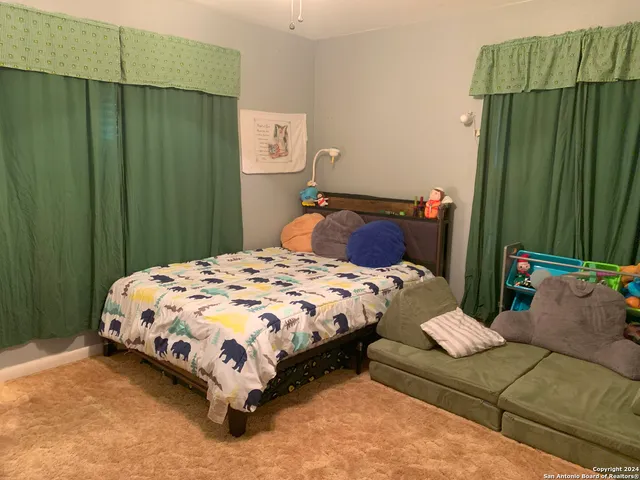 a bedroom with a bed and green walls