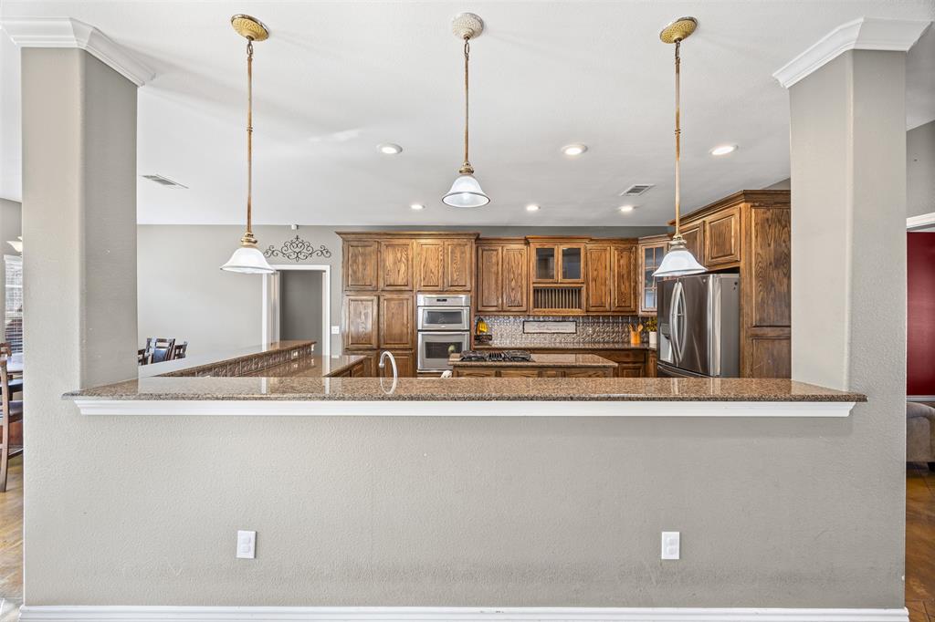 905 Royse Ridge Road Ennis, TX 75119 - Photo 14 of 38 a view of a center island in the kitchen