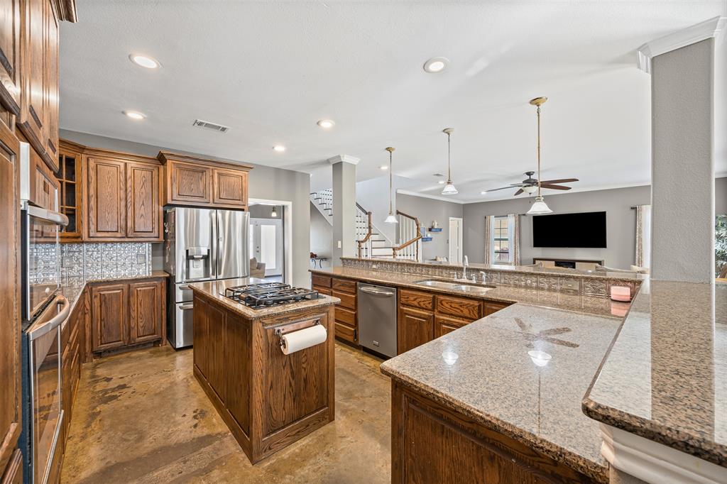 905 Royse Ridge Road Ennis, TX 75119 - Photo 17 of 38 a kitchen with stainless steel appliances granite countertop stove top oven and cabinets