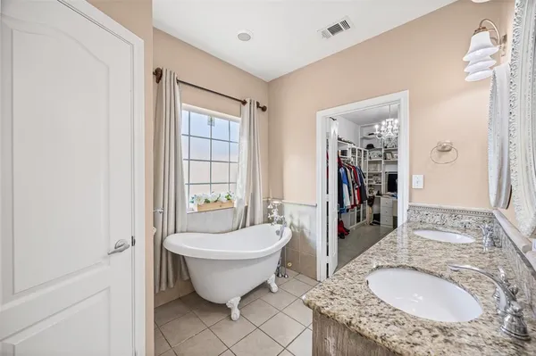 a spacious bathroom with a granite countertop sink and a mirror