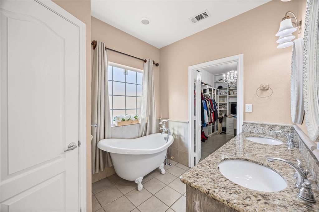 905 Royse Ridge Road Ennis, TX 75119 - Photo 22 of 38 a spacious bathroom with a granite countertop sink and a mirror