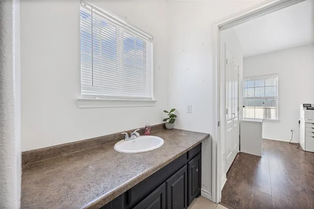 a bathroom with a sink granite and a mirror