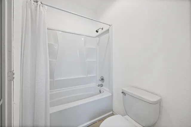 a bathroom with a toilet and a bathtub