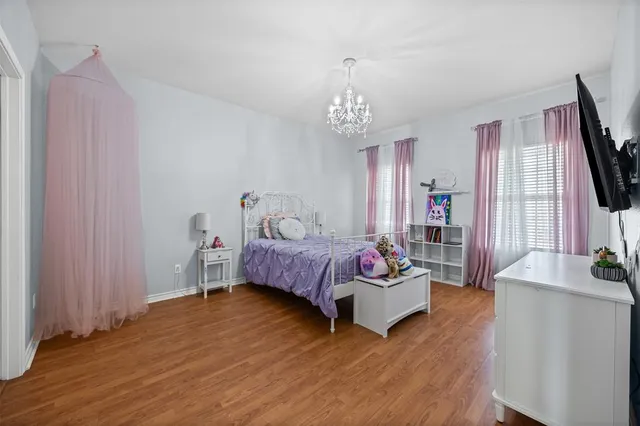 a bedroom with furniture and a flat screen tv