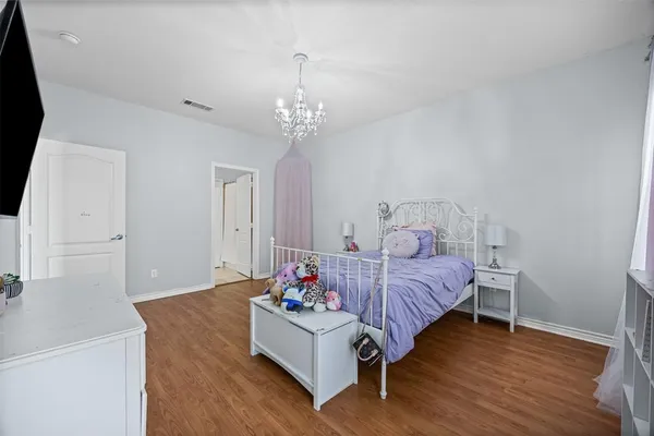 a bed room with furniture and a chandelier