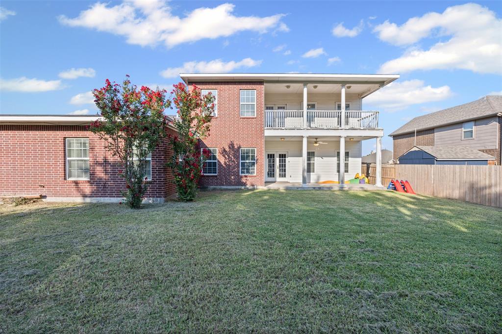 905 Royse Ridge Road Ennis, TX 75119 - Photo 37 of 38 a view of a house with a backyard and a garden