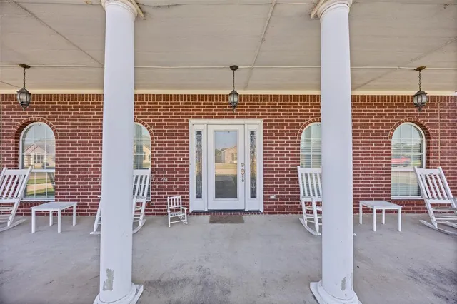 a front view of a house with wooden fence